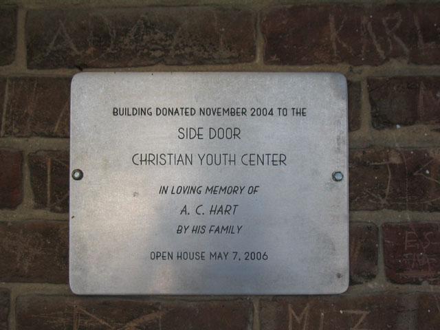 Plaque on building of the Side Door