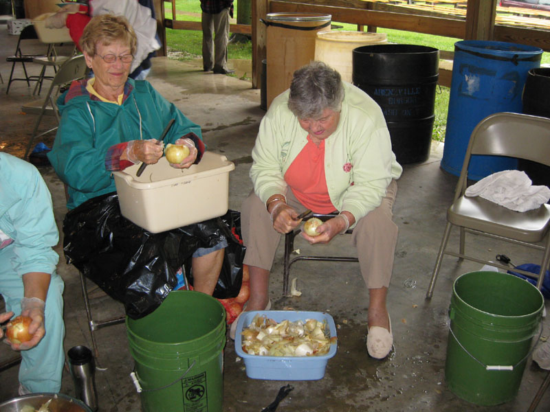 Rosalie Schone and Barbara Fowler, of Brook Park, OH, peel onions.