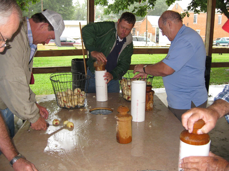 Some volunteers used the new choppers, and others quartered the potatoes the old-fashioned way.