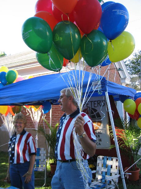Wes and Linda Hendricker give away balloons, copies of the New Testament and bookmarks to promote the ministry of St. Peter's Lutheran Church.