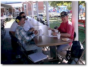 The Peck brothers, Dick (left) and Bob (right), enjoy a bowl of burgoo for their breakfast.