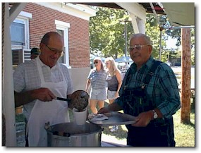 Gib Harbin dishes up a bowl of soup for Dean Stock.