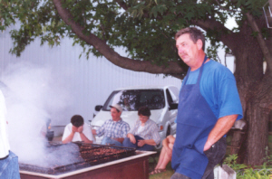 Mike Beck watches over the grill.