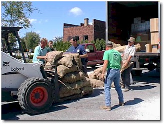 Unloading potatoes. (Marc Carls, Brian Millard, truck driver, Gale Kleinschmidt, Tony Thomas.