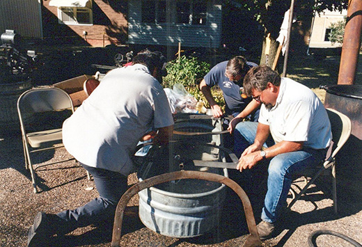 group of men cleaning stirrers